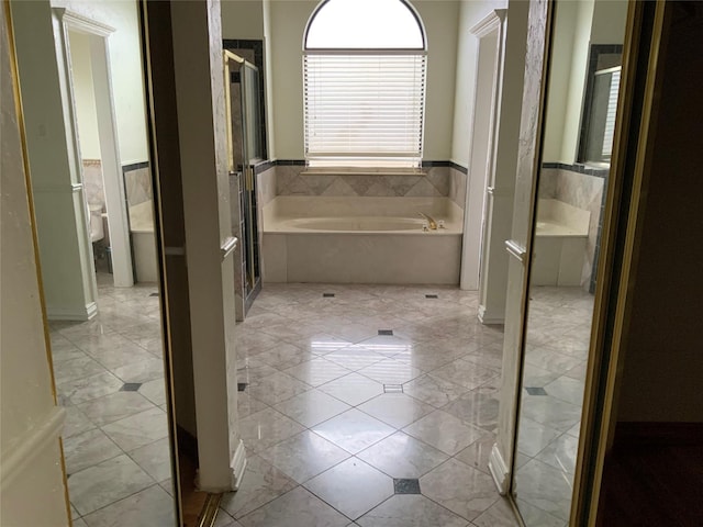 bathroom featuring tile patterned floors and independent shower and bath