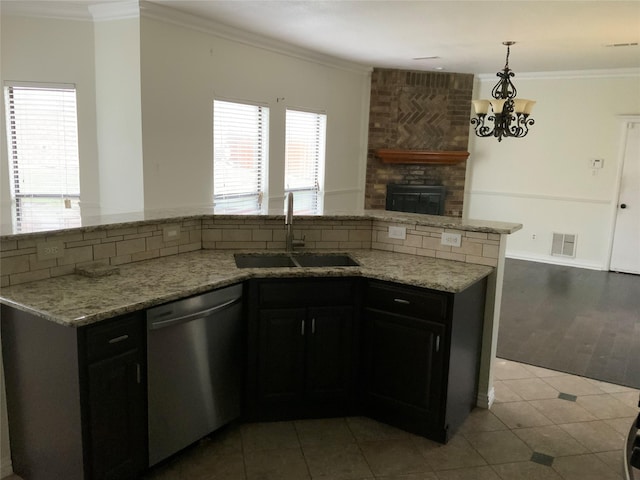 kitchen with decorative backsplash, a wealth of natural light, dishwasher, and sink