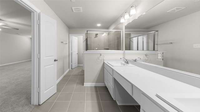 bathroom featuring tile patterned floors, a shower with door, vanity, and ceiling fan