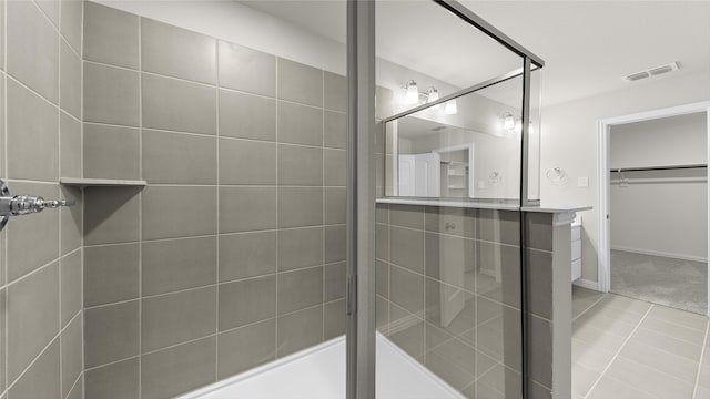 bathroom with tile patterned flooring and a shower with shower door