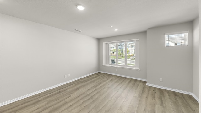 unfurnished room with light hardwood / wood-style flooring