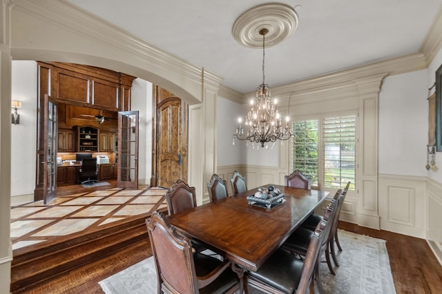 dining area featuring french doors and a chandelier