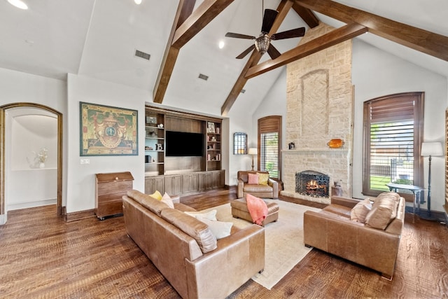 living room with beam ceiling, built in features, high vaulted ceiling, and plenty of natural light