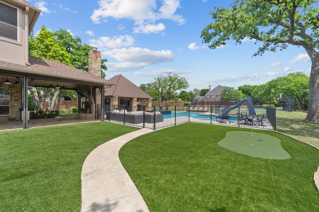 exterior space with ceiling fan, a patio area, and a fenced in pool