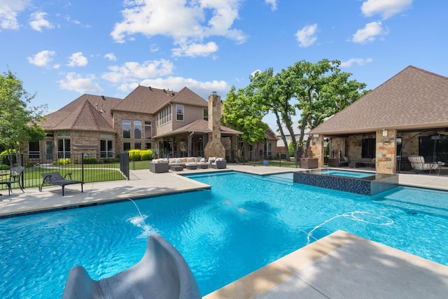 view of swimming pool featuring an in ground hot tub, pool water feature, a patio, and an outdoor hangout area