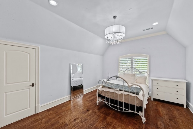 bedroom featuring dark hardwood / wood-style floors, an inviting chandelier, and vaulted ceiling