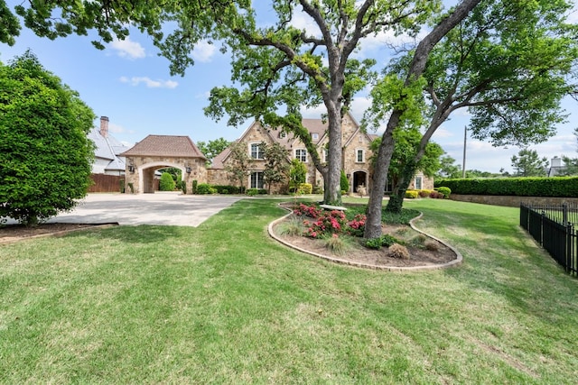 tudor house with a gazebo and a front yard