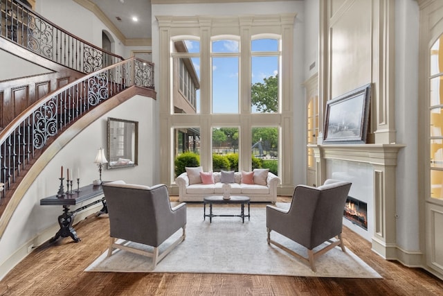 living room with a high ceiling and wood-type flooring