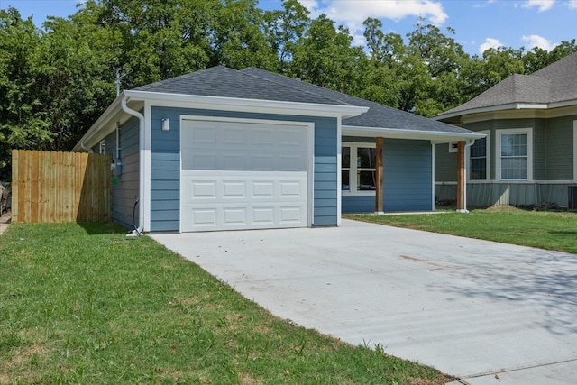 view of front of property with a garage and a front lawn