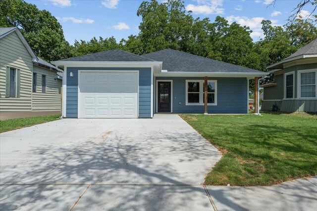 view of front of property with a garage and a front yard