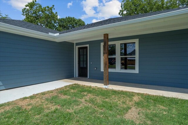 doorway to property with a yard