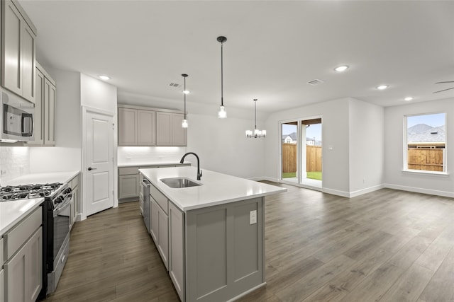 kitchen featuring stainless steel appliances, gray cabinetry, and sink