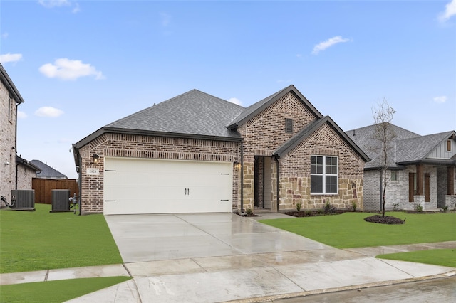 view of front of house with cooling unit, a front lawn, and a garage