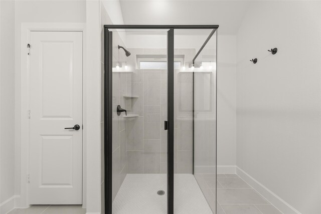 bathroom featuring tile patterned flooring and a shower with door