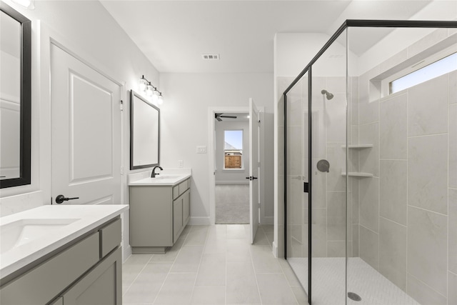 bathroom featuring ceiling fan, tile patterned flooring, vanity, and walk in shower