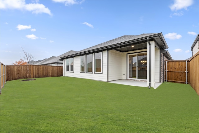 rear view of property featuring a patio and a lawn