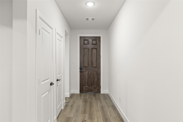 hall with light hardwood / wood-style flooring