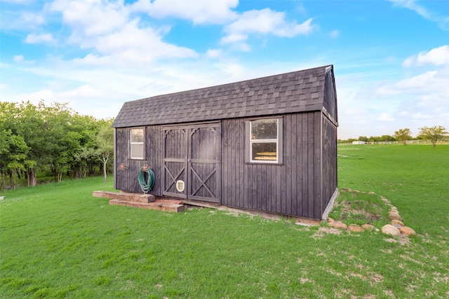 view of outbuilding with a lawn