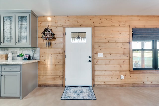 foyer with wooden walls