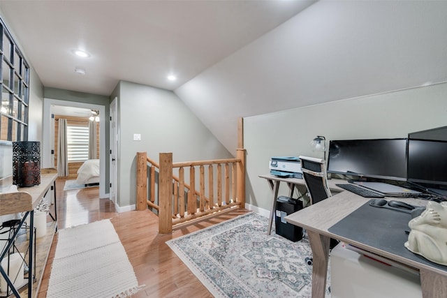 office featuring ceiling fan, vaulted ceiling, and light hardwood / wood-style flooring