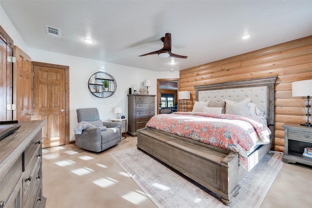 bedroom featuring log walls and ceiling fan