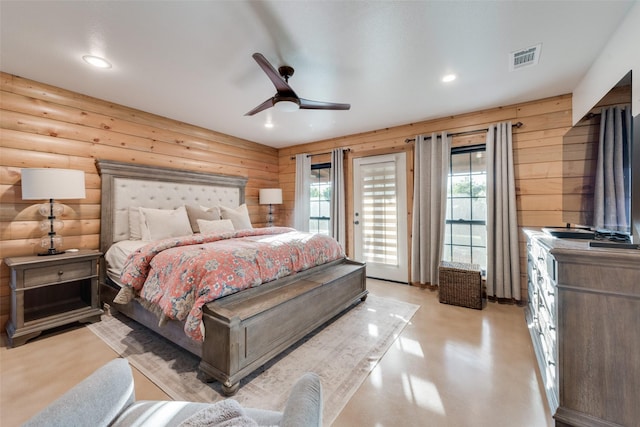 bedroom featuring log walls, access to outside, and ceiling fan