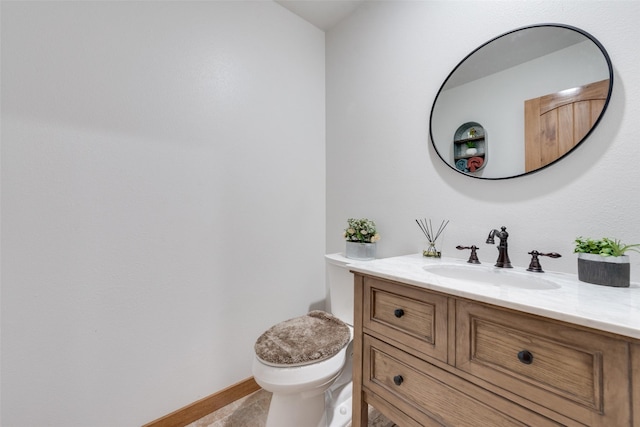 bathroom with tile patterned flooring, vanity, and toilet