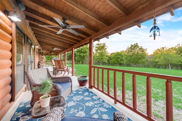 exterior space featuring ceiling fan and a lawn