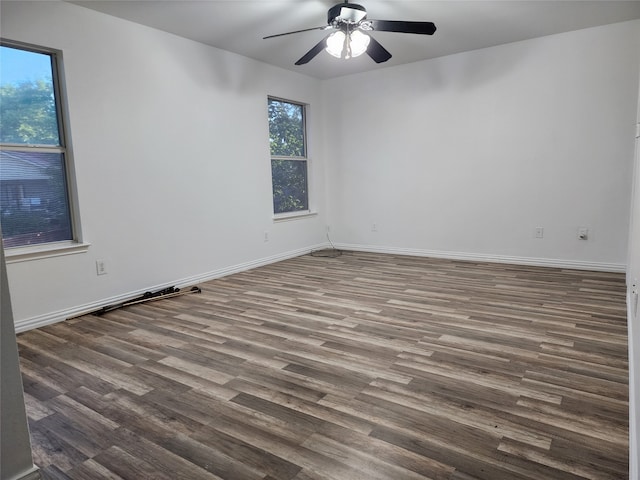 unfurnished room with dark hardwood / wood-style floors and ceiling fan