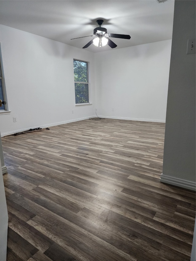 spare room with dark wood-type flooring and ceiling fan