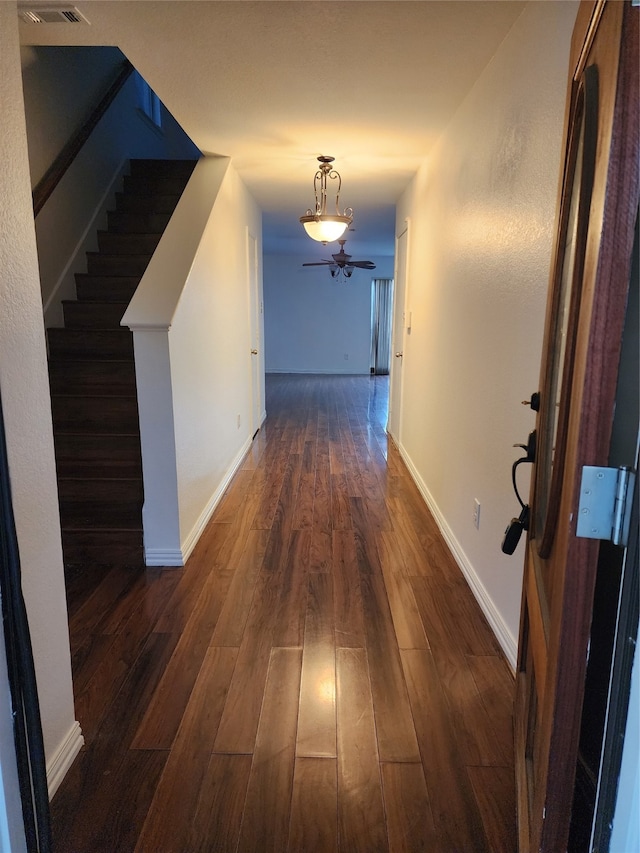 hallway with dark hardwood / wood-style floors