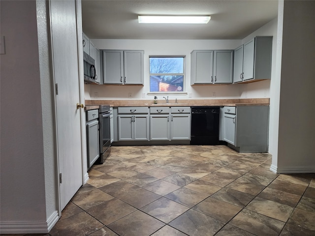 kitchen featuring sink, tile flooring, gray cabinets, and stainless steel appliances