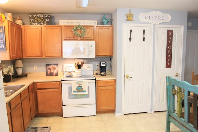 kitchen with white appliances and sink