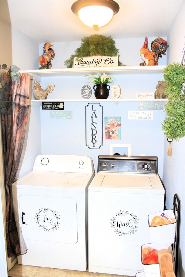 washroom featuring light tile patterned floors and washer and clothes dryer