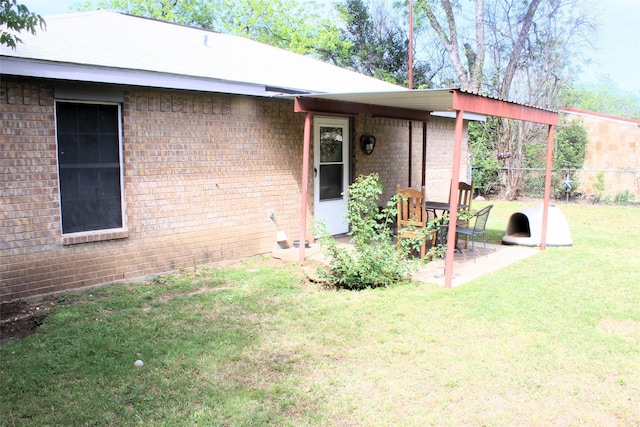 property entrance featuring a yard and a patio