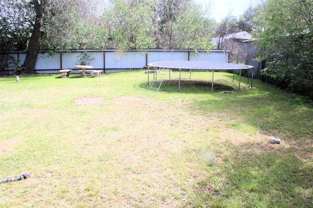 view of yard with a trampoline