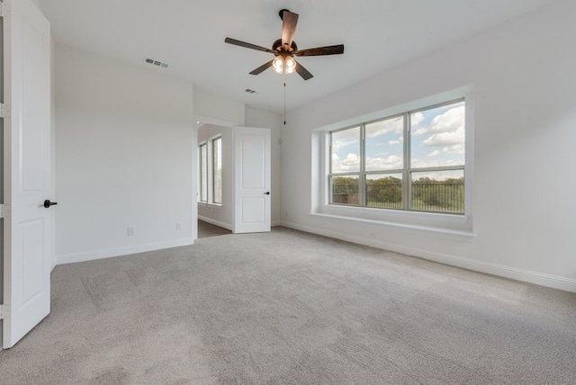 unfurnished bedroom with light carpet and ceiling fan