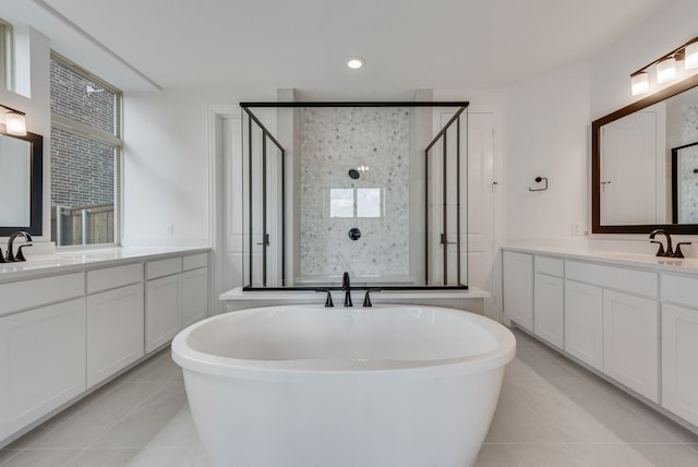 bathroom featuring tile patterned flooring, vanity, and plus walk in shower