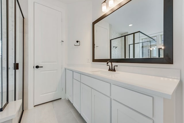 bathroom featuring tile patterned flooring, vanity, and an enclosed shower