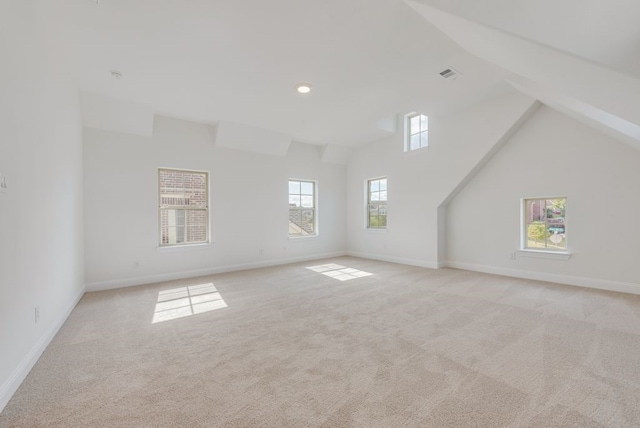 additional living space with lofted ceiling and light carpet