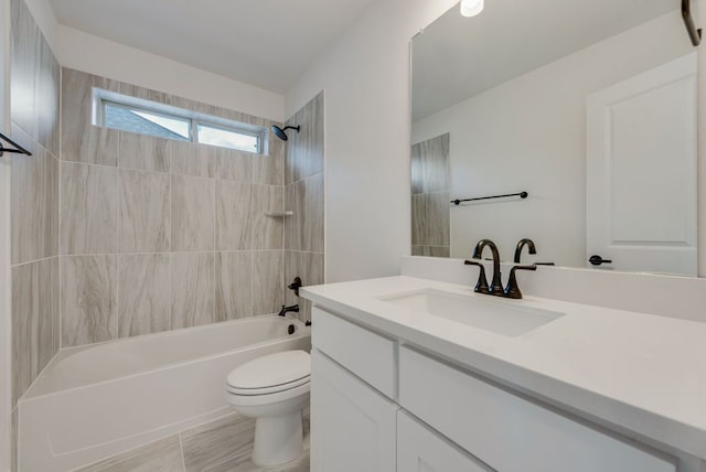 full bathroom featuring vanity, toilet, and tiled shower / bath