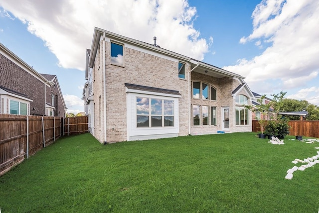 back of house featuring a yard