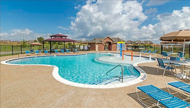 view of swimming pool with a gazebo, a patio area, and pool water feature