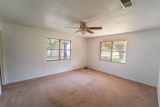 carpeted spare room featuring ceiling fan