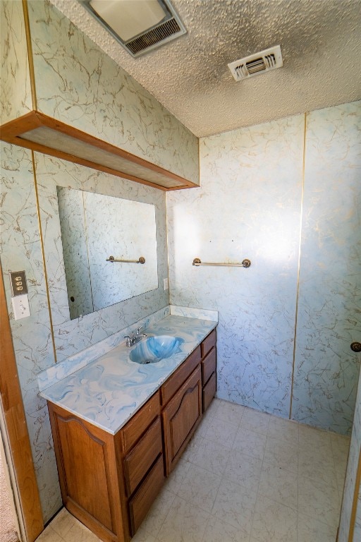 bathroom featuring vanity, tile floors, and a textured ceiling