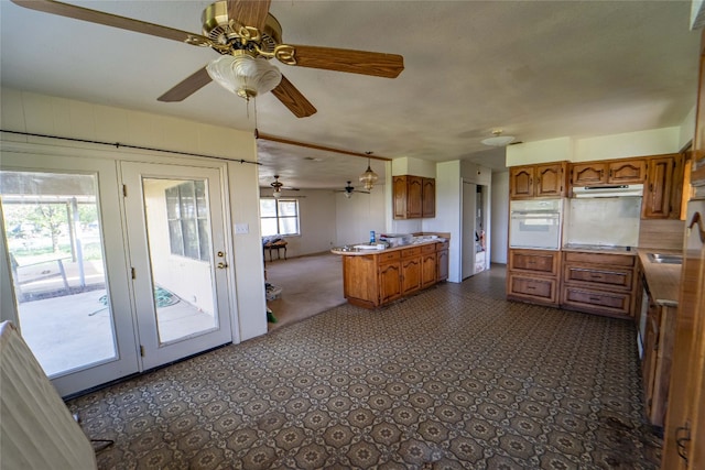 kitchen featuring french doors, oven, dark tile flooring, and ceiling fan