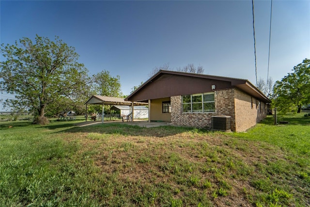 exterior space with a yard and central AC