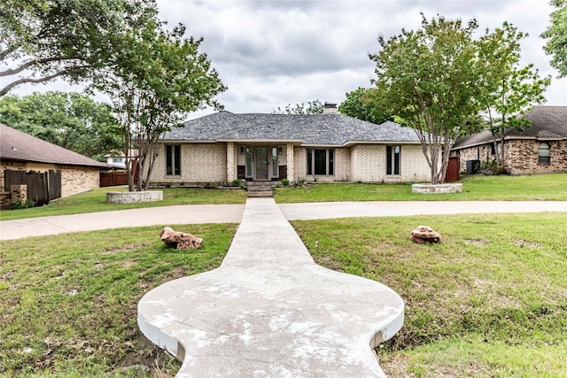 single story home featuring a front yard and central AC unit