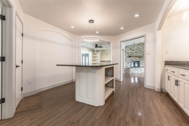 kitchen with a kitchen island, dark hardwood / wood-style flooring, white cabinets, and sink