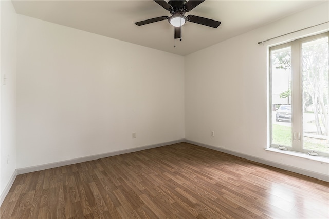 empty room with wood-type flooring and ceiling fan